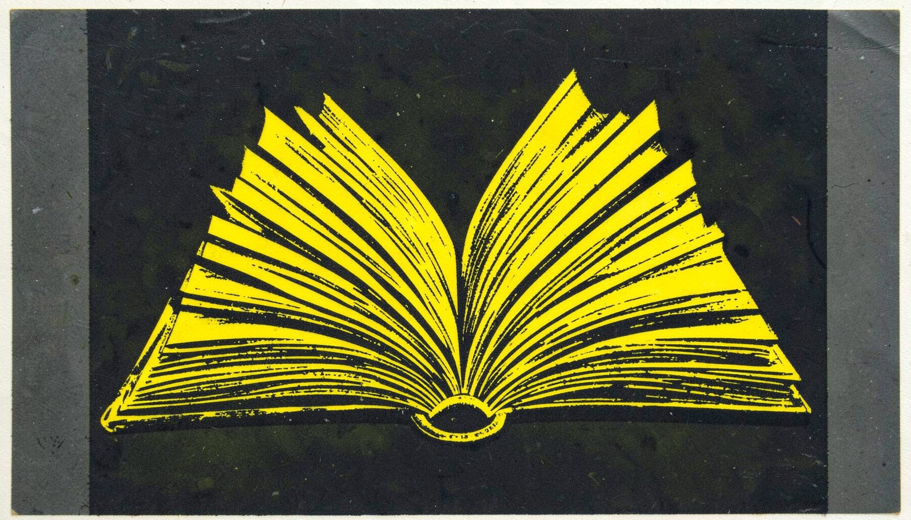 A carved linocut relief print of an open book with pages fanning outward against a dark scholarly backdrop